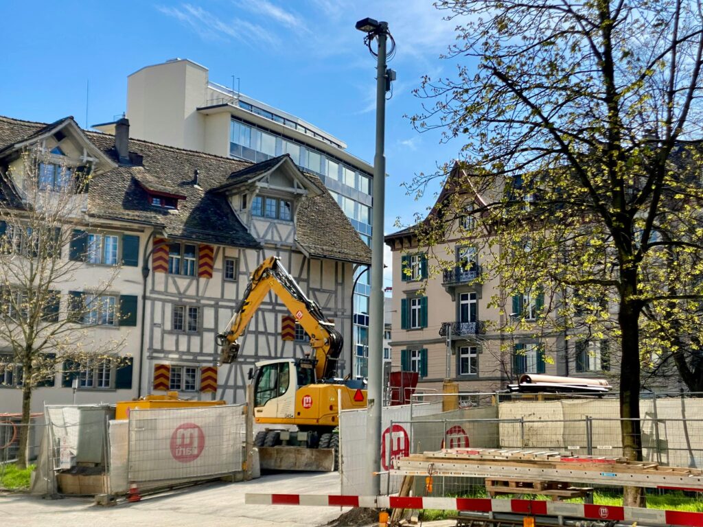 Construction site in Zurich with traditional and modern architecture.